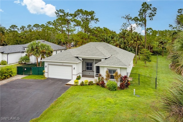 view of front of house featuring a front lawn and a garage