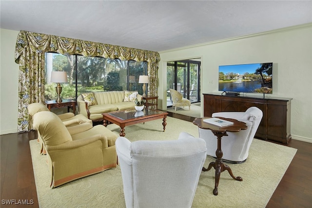 living room with hardwood / wood-style floors and crown molding