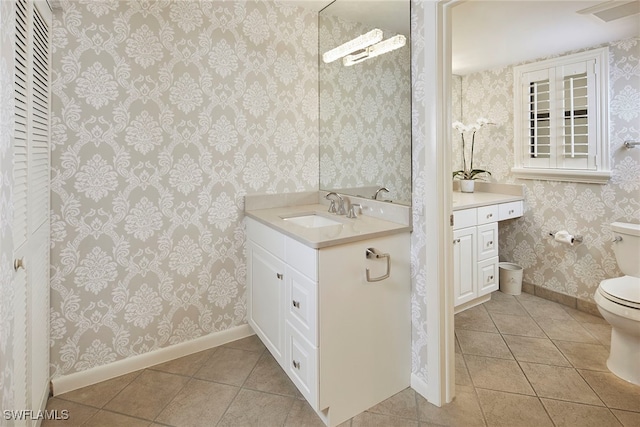 bathroom featuring toilet, vanity, and tile patterned floors