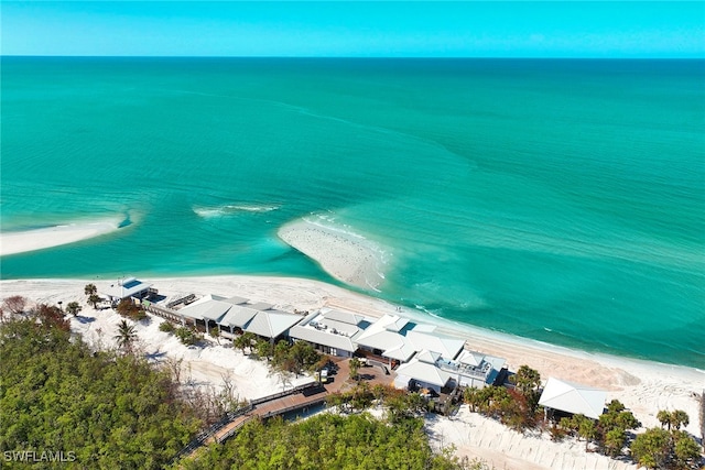 bird's eye view featuring a water view and a beach view