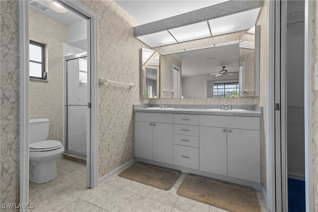 bathroom with toilet, vanity, tile patterned floors, and a shower with shower door