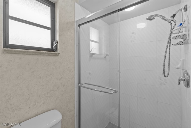 bathroom with toilet and walk in shower