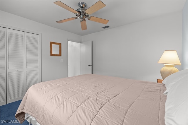 carpeted bedroom with a closet and ceiling fan