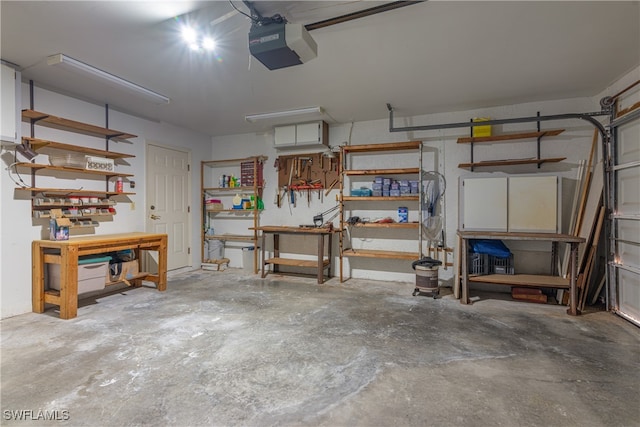 garage with a workshop area and a garage door opener