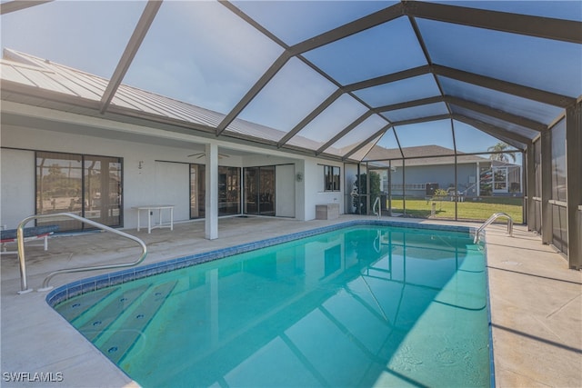 view of pool with a patio, ceiling fan, and a lanai