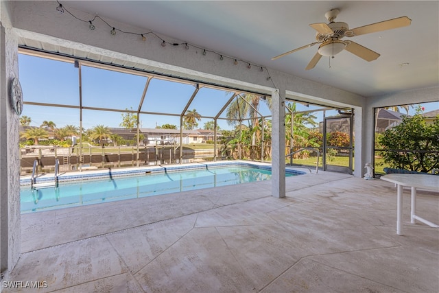 view of pool with a patio area, ceiling fan, and a lanai