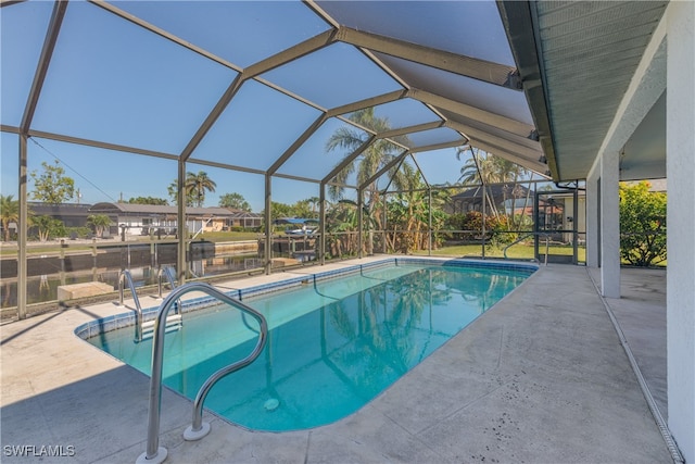 view of swimming pool featuring a lanai and a patio