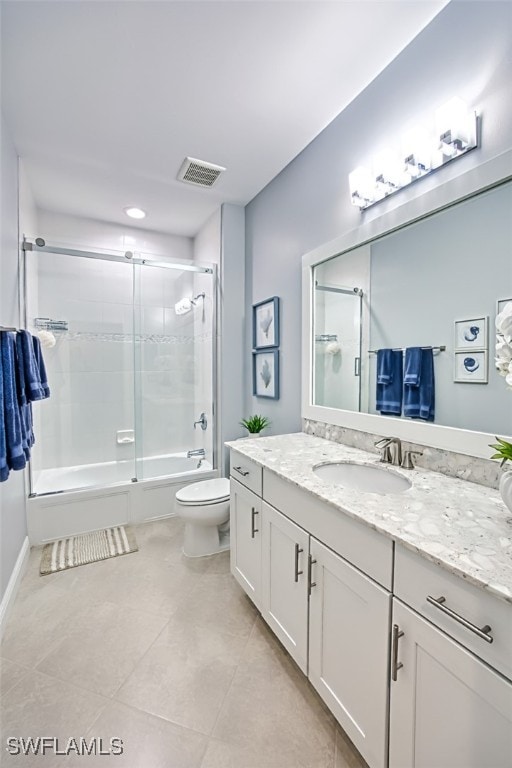 full bathroom with toilet, tile patterned floors, vanity, and shower / bath combination with glass door