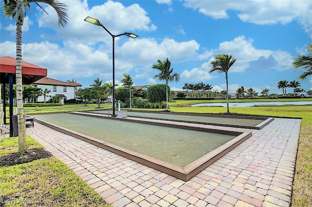 view of home's community with a yard and a water view