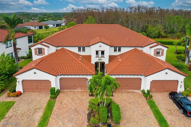 mediterranean / spanish home with a garage