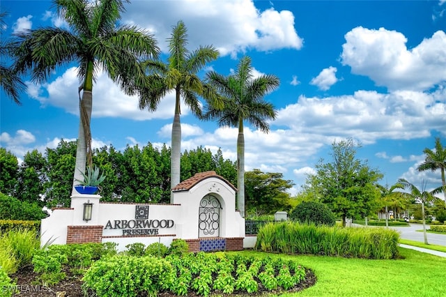 community / neighborhood sign with a lawn