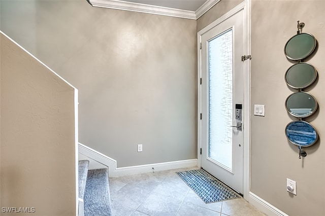 foyer with light tile patterned floors and crown molding