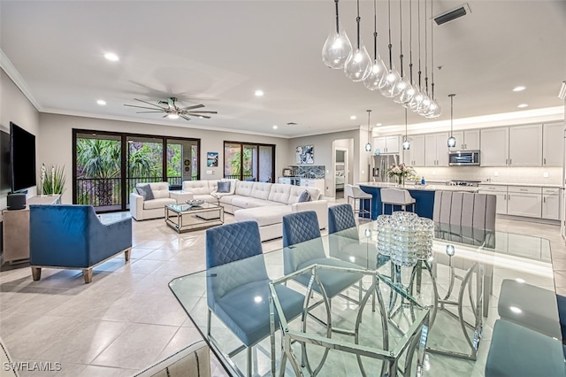 dining area featuring ornamental molding, ceiling fan, and light tile patterned floors