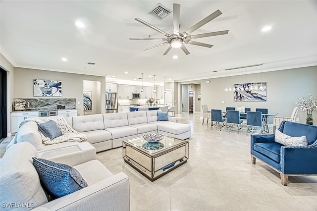 tiled living room with ceiling fan and crown molding