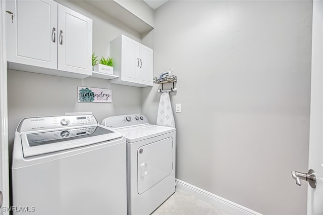 washroom featuring cabinets and washer and dryer