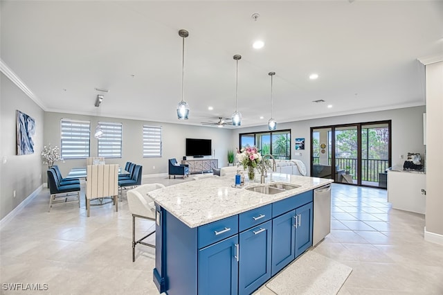 kitchen featuring a center island with sink, sink, stainless steel dishwasher, ceiling fan, and light stone countertops