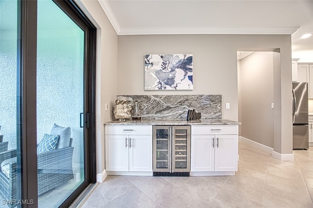 bar with wine cooler, white cabinetry, crown molding, and stainless steel fridge