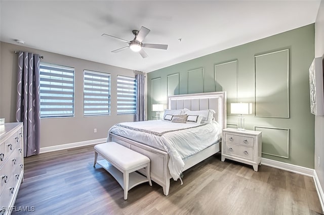 bedroom with hardwood / wood-style floors and ceiling fan