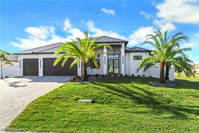 view of front of home featuring a garage and a front lawn