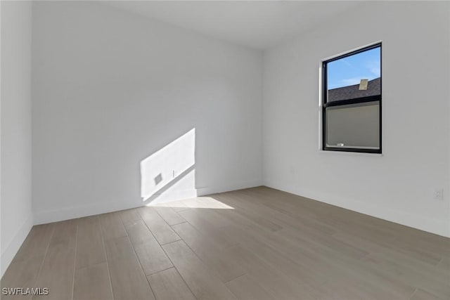 spare room featuring light hardwood / wood-style floors