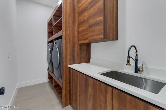 laundry area featuring sink and independent washer and dryer