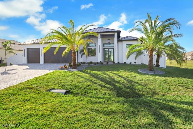 view of front of home featuring a garage and a front yard