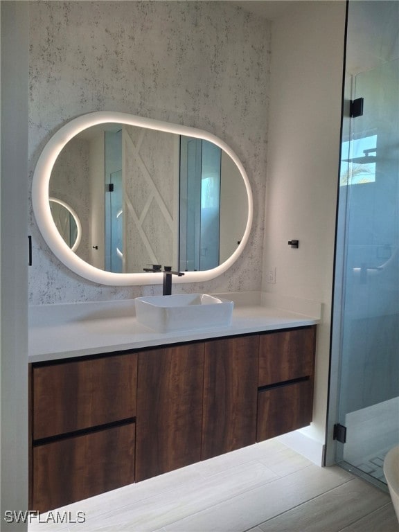 bathroom with vanity and a shower with shower door