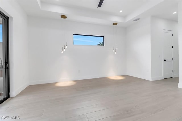 empty room featuring a raised ceiling