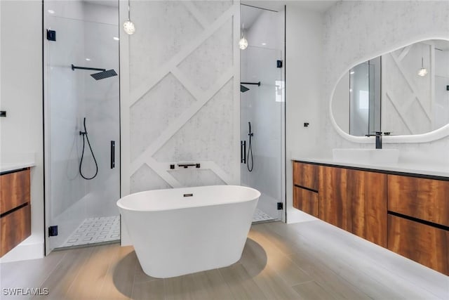 bathroom featuring vanity and separate shower and tub