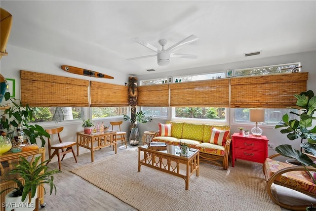 sunroom / solarium with visible vents and ceiling fan