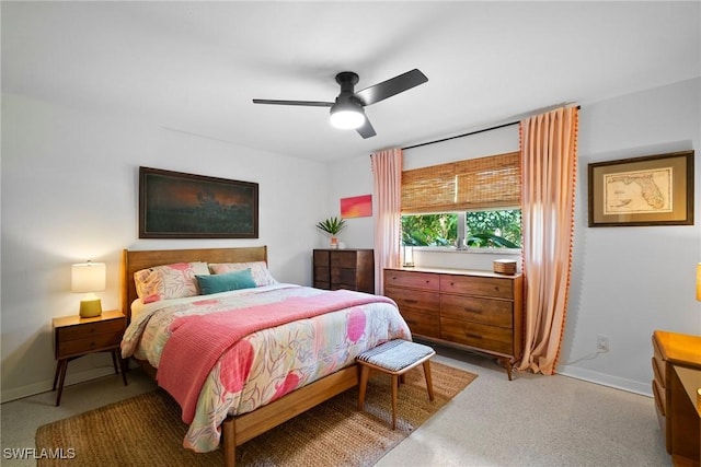 bedroom with ceiling fan and baseboards