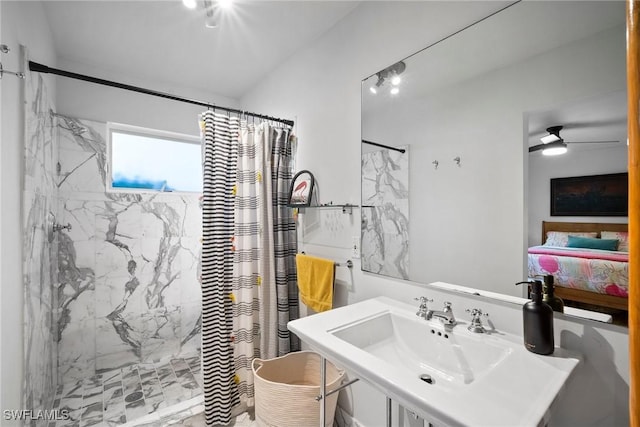 ensuite bathroom featuring ensuite bath, a shower stall, a ceiling fan, and a sink