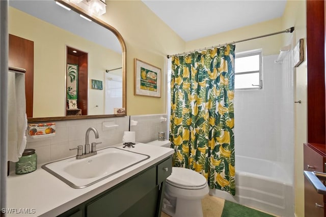 bathroom featuring vanity, tile walls, toilet, and shower / bath combo