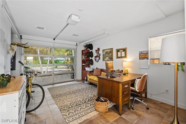 home office with visible vents and a garage