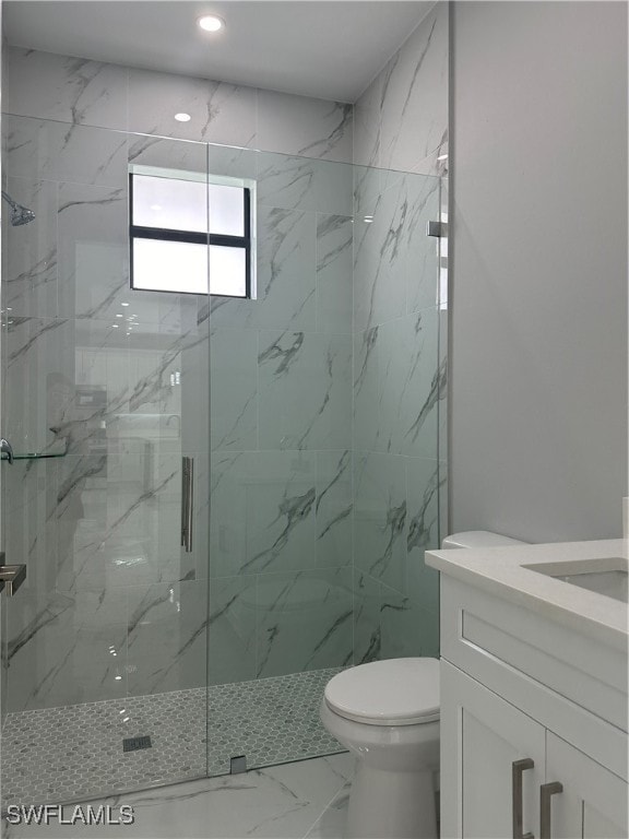 bathroom with vanity, toilet, and an enclosed shower