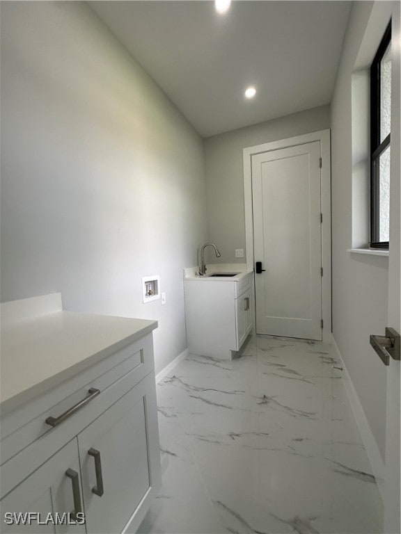 laundry room featuring cabinets, hookup for a washing machine, and sink