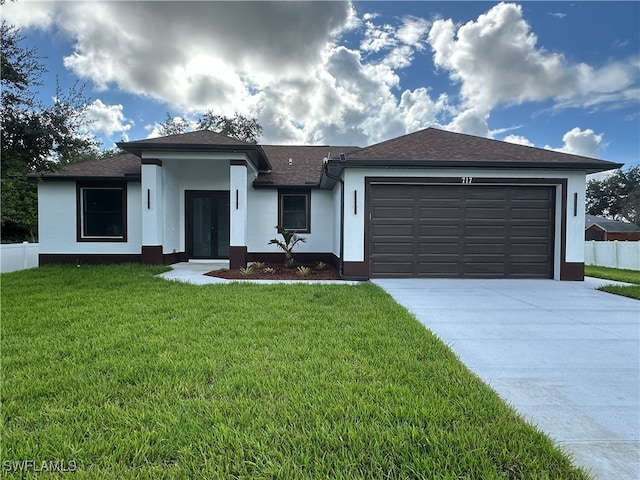 view of front of property featuring a garage and a front yard