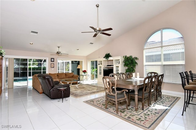 tiled dining space featuring ceiling fan and lofted ceiling