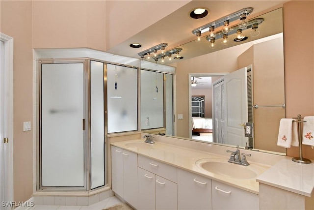 bathroom with ceiling fan, a shower with door, vanity, and tile patterned flooring