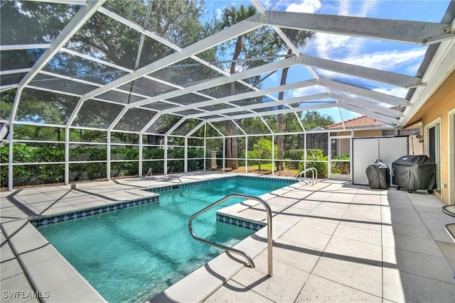 view of swimming pool featuring a lanai, area for grilling, and a patio area