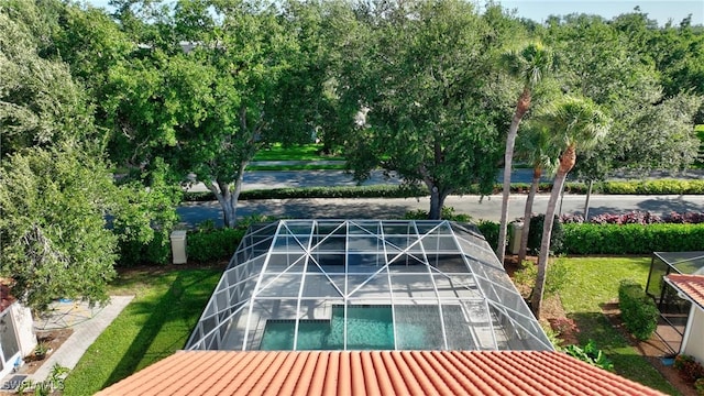 view of swimming pool with glass enclosure