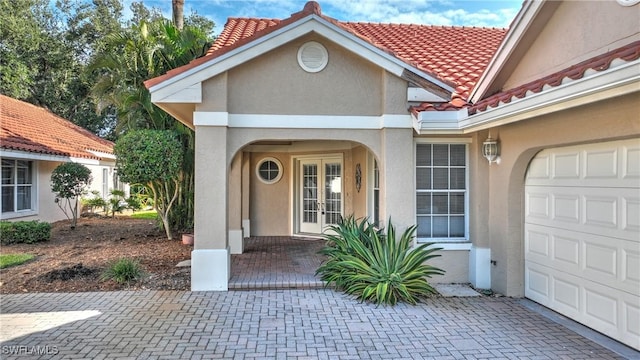 view of exterior entry with a garage