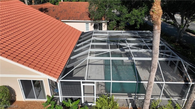 view of side of property featuring a lanai