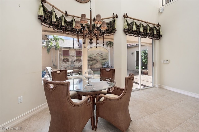 tiled dining room featuring a chandelier