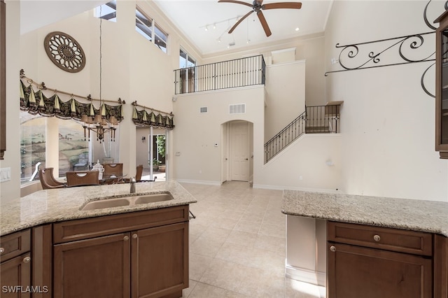 kitchen featuring a high ceiling, plenty of natural light, and sink