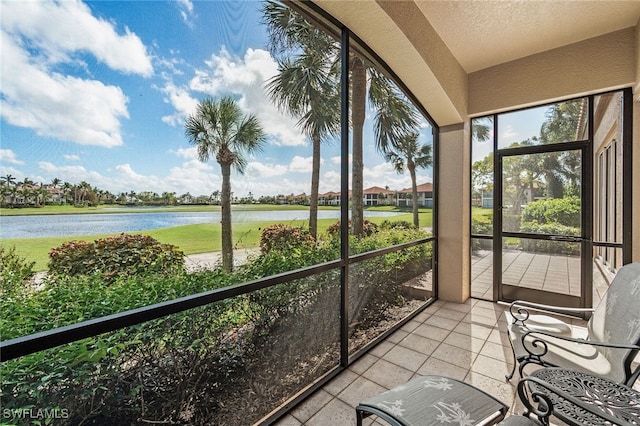 unfurnished sunroom featuring a water view