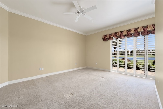 spare room with baseboards, carpet flooring, and crown molding