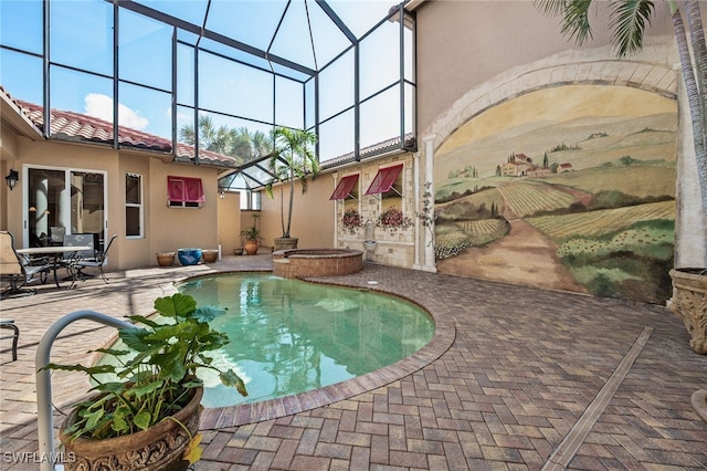 view of pool with glass enclosure, an in ground hot tub, and a patio area