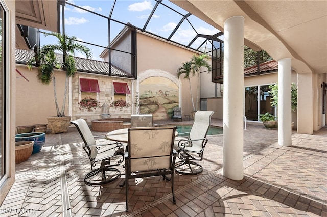 view of patio featuring a lanai