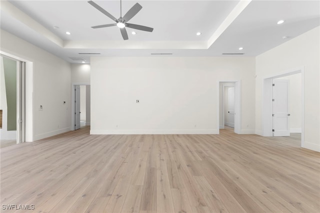 3509 5th Ave SW, Naples, FL 34117 - unfurnished living room featuring a ceiling fan, light wood-type flooring, a raised ceiling, and recessed lighting